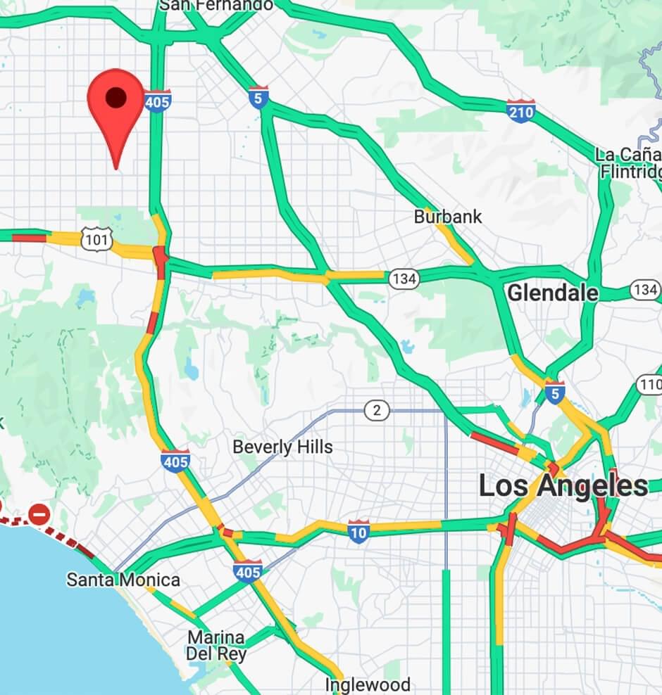 An interior view of a moody, black-walled studio lounge featuring "Legacy Makers" movie posters, branded apparel, and a crystal chandelier. A "Recording" sign is lit above a doorway leading to a professional media room.